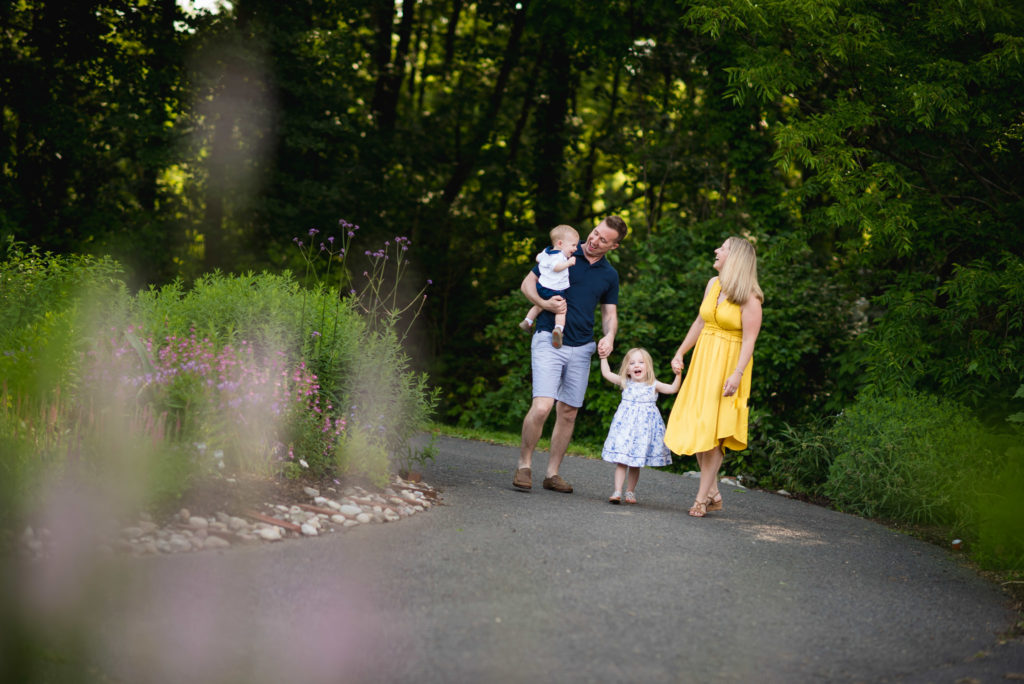 Family dressed in yellow and blue for walking in Meadowlark Gardens in Northern Virginia while flowers bloom in spring