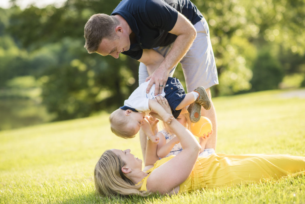 Family plays in the grass at Meadowlark Gardens in Northern Virginia