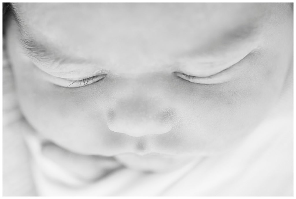 close up of baby's eyelashes in black and white