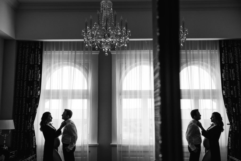 black and white photo of man and woman getting ready for maternity photos in DC at luxury hotel in DC