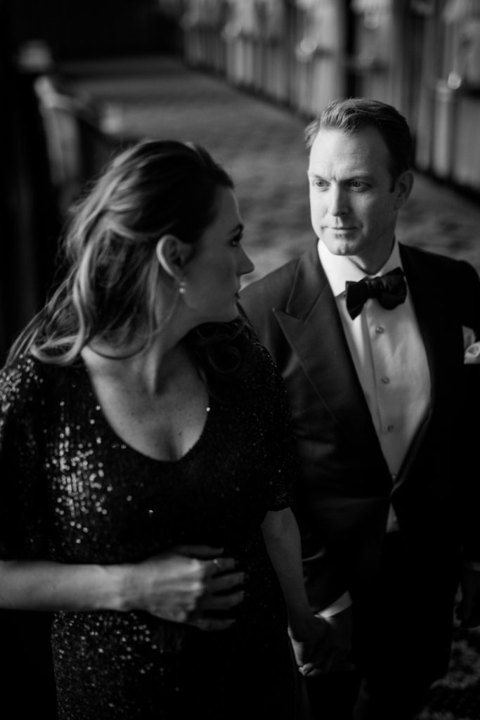 maternity photo session at luxury hotel in DC with woman in black sequin gown and man in black suit with bowtie